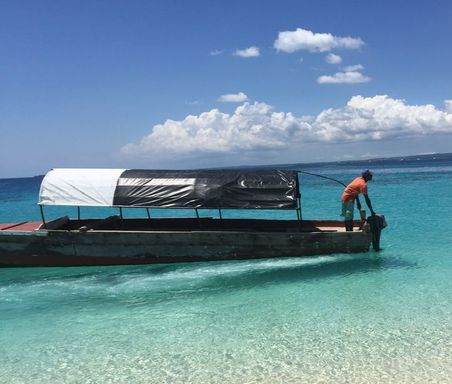 Boat in zanzibar crystal clear beach water